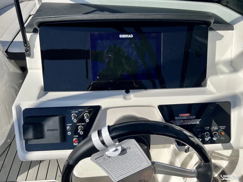 Slide: The Image of 2023 Sea Ray SPX 210 dashboard with Simrad display and controls. - 4