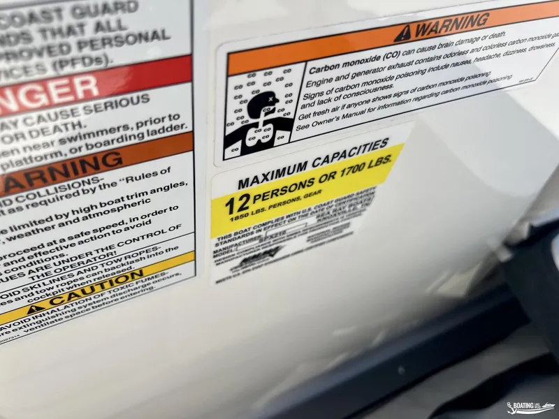 Slide: The Image of Warning labels on 2023 Sea Ray SPX 210 boat, maximum capacity 12 persons or 1700 lbs. - 5