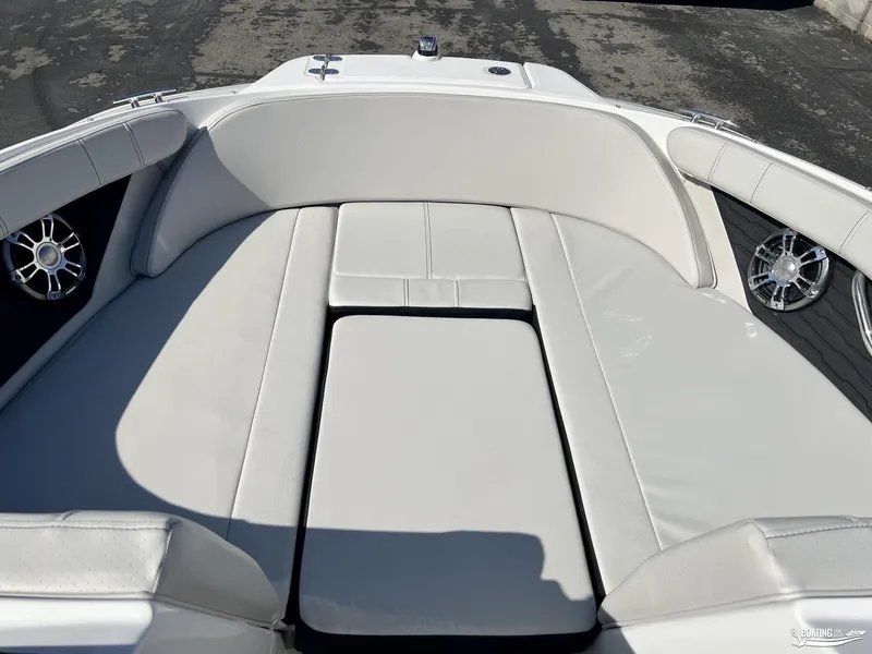Slide: The Image of 2023 Sea Ray SPX 210 boat interior with white cushioned seating and speakers. - 6