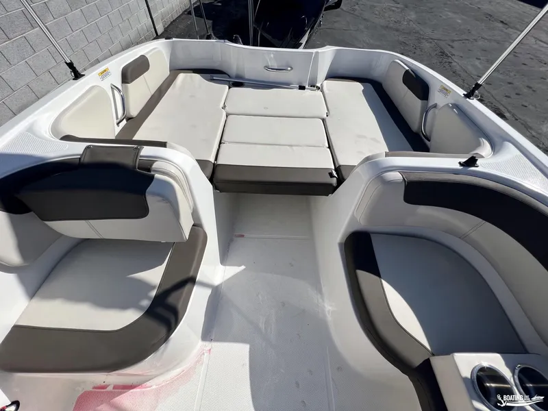 Slide: The Image of 2023 Bayliner E18 boat interior with spacious seating and modern design. - 8
