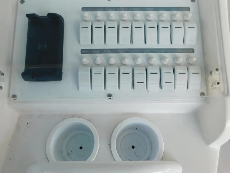 Slide: The Image of Control panel of 2007 Donzi 38 ZFX boat with switches and holders. - 19