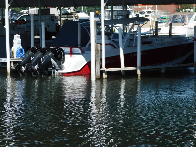 Slide: The Image of 2007 Donzi 38 ZFX boat docked with three outboard motors. - 4