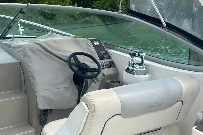 Slide: The Image of Interior view of 2011 Sea Ray Sundancer 280 boat cockpit with steering wheel and controls. - 18