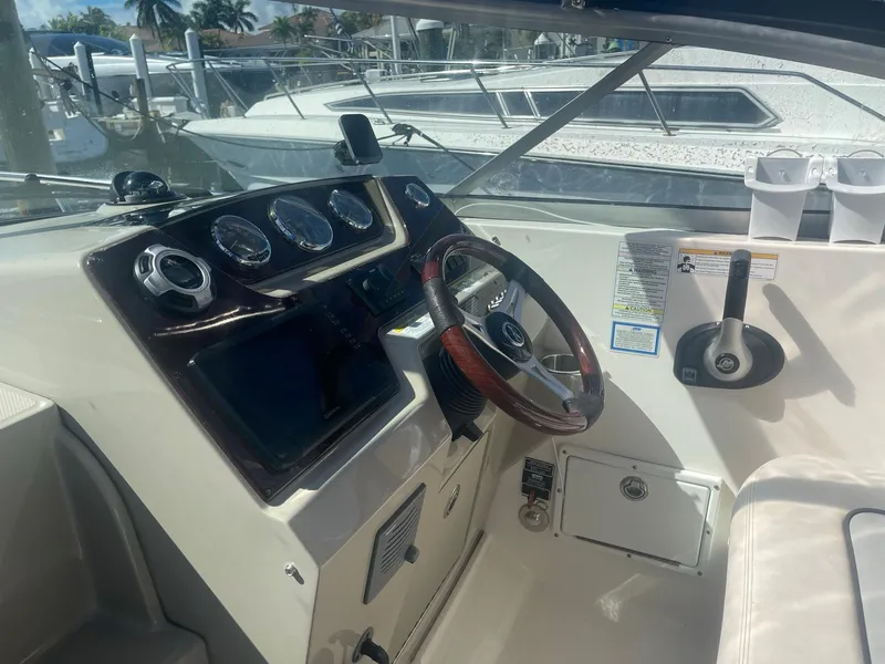 Slide: The Image of Cockpit of 2011 Sea Ray Sundancer 280 with steering wheel and gauges. - 19