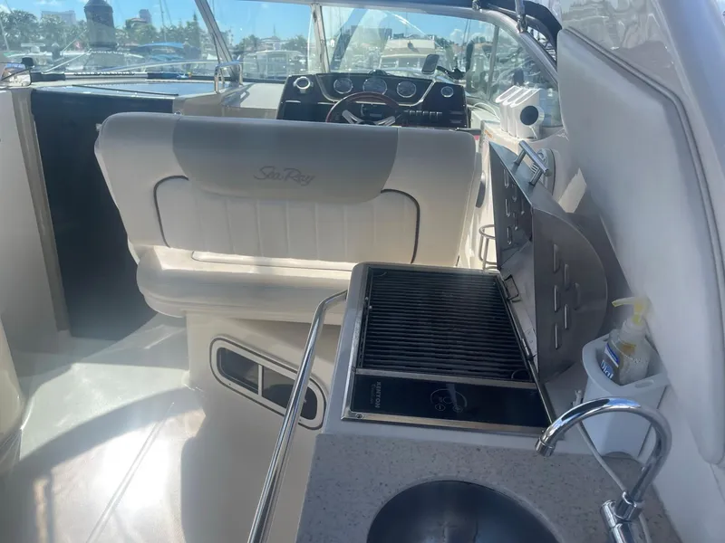 Slide: The Image of Interior of a 2011 Sea Ray Sundancer 280 yacht with helm and kitchenette. - 32