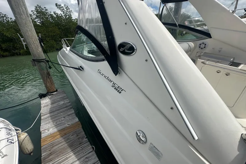 Slide: The Image of 2011 Sea Ray Sundancer 280 docked, showcasing sleek white exterior and modern design. - 33
