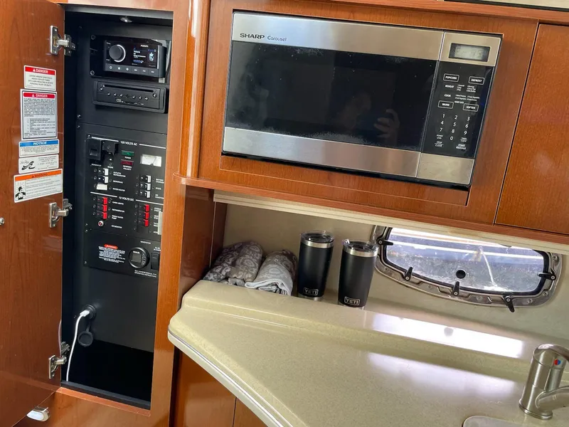 Slide: The Image of Interior of Sea Ray Sundancer 280 with microwave and control panel. - 43