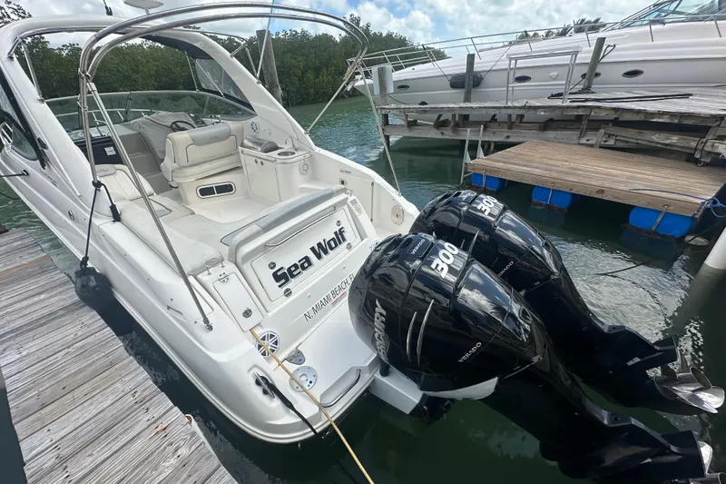 Slide: The Image of 2011 Sea Ray Sundancer 280 boat docked, featuring twin Mercury outboard engines. - 53