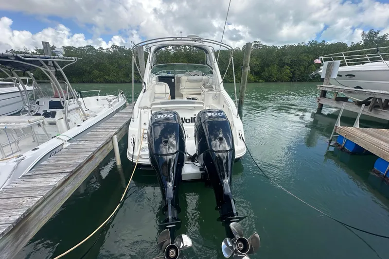 Slide: The Image of 2011 Sea Ray Sundancer 280 docked with twin outboard engines, surrounded by calm waters. - 57