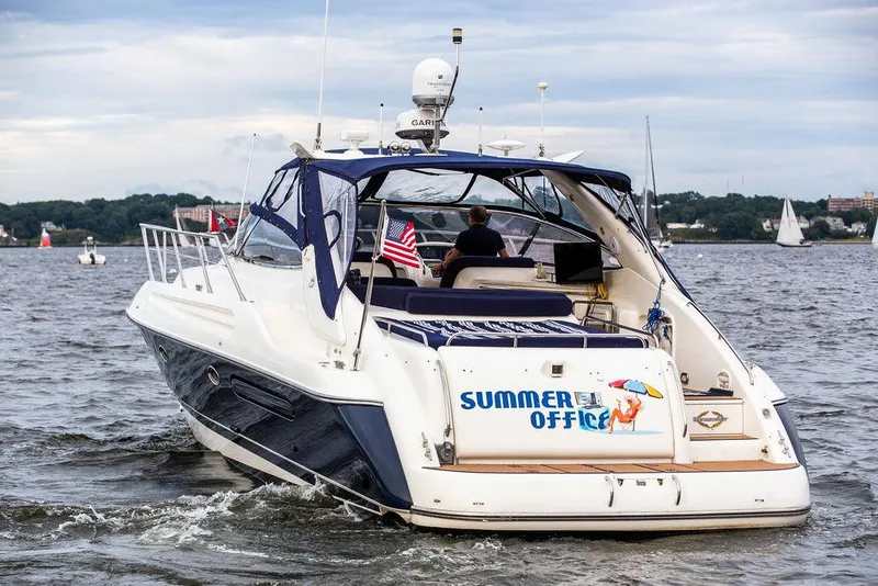 Slide: The Image of 1999 Sunseeker Camargue yacht with $250k upgrades, named Summer Office, cruising on a lake. - 19