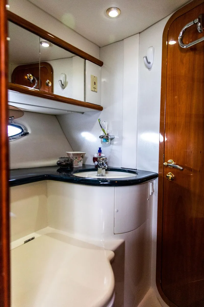 Slide: The Image of 1999 Sunseeker Camargue yacht bathroom with modern upgrades, sleek design, and wooden accents. - 23