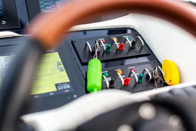 Slide: The Image of Close-up of 1999 Sunseeker Camargue yacht control panel with upgraded switches and navigation display. - 31