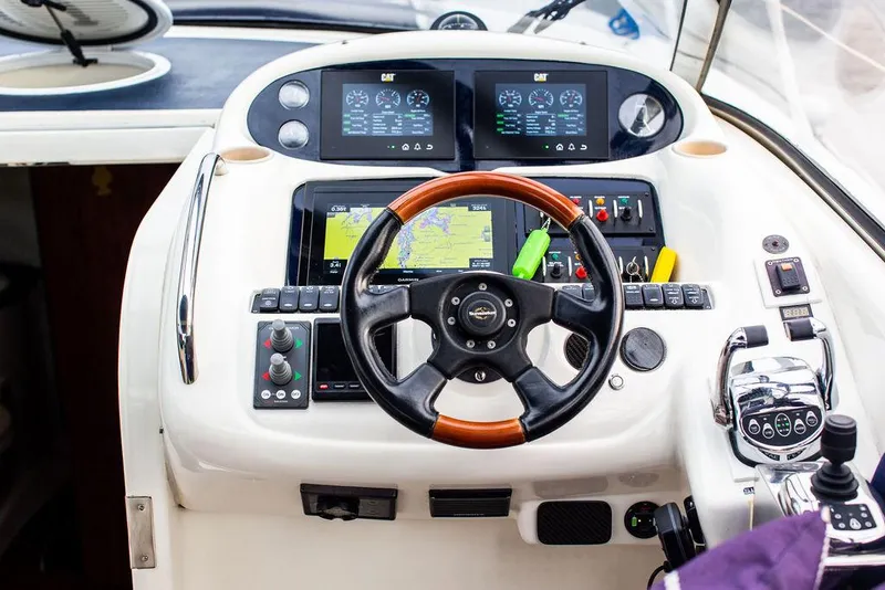 Slide: The Image of 1999 Sunseeker Camargue yacht helm with modern upgrades and navigation systems. - 39