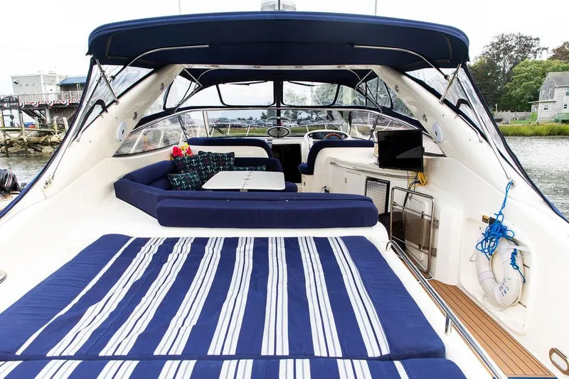 Slide: The Image of 1999 Sunseeker Carmargue yacht with $250k in upgrades, featuring luxurious seating and modern amenities. - 4
