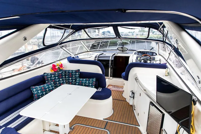 Slide: The Image of 1999 Sunseeker Camargue yacht interior with $250k in upgrades, featuring a luxurious seating area. - 42