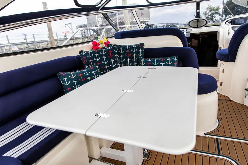 Slide: The Image of 1999 Sunseeker Camargue yacht interior with upgraded seating and dining area. - 44