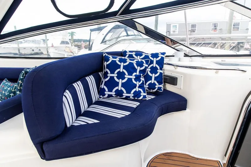 Slide: The Image of 1999 Sunseeker Carmargue yacht interior with upgraded seating and nautical-themed cushions. - 47