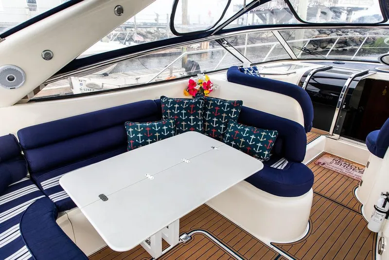 Slide: The Image of 1999 Sunseeker Camargue yacht interior with upgraded seating and table. - 48