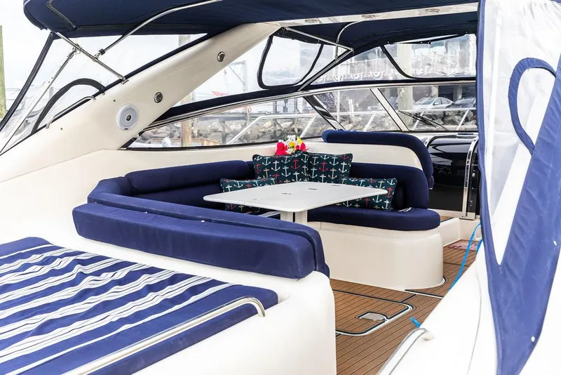 Slide: The Image of 1999 Sunseeker Carmargue yacht with $250k in upgrades, featuring luxurious seating and dining area. - 5