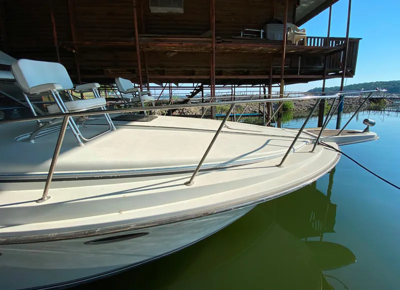 Slide: The Image of 1984 Trojan 10 Meter Sedan boat docked at a marina. - 10
