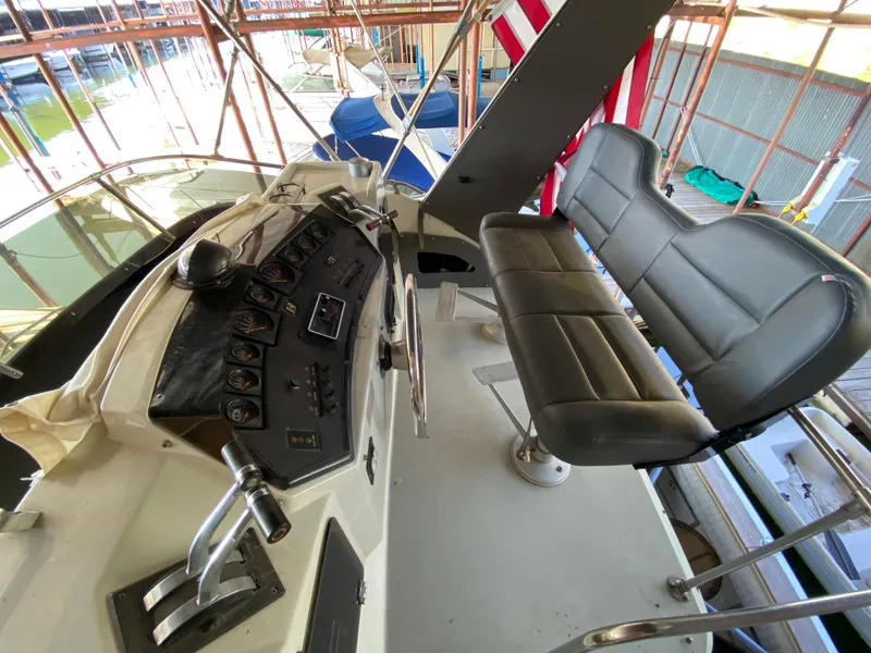 Slide: The Image of 1984 Trojan 10 Meter Sedan boat helm with dual seats and control panel. - 17