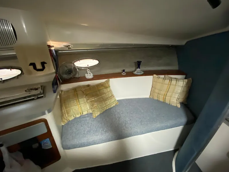 Slide: The Image of 1984 Trojan 10 Meter Sedan cabin interior with cozy seating and decorative pillows. - 32