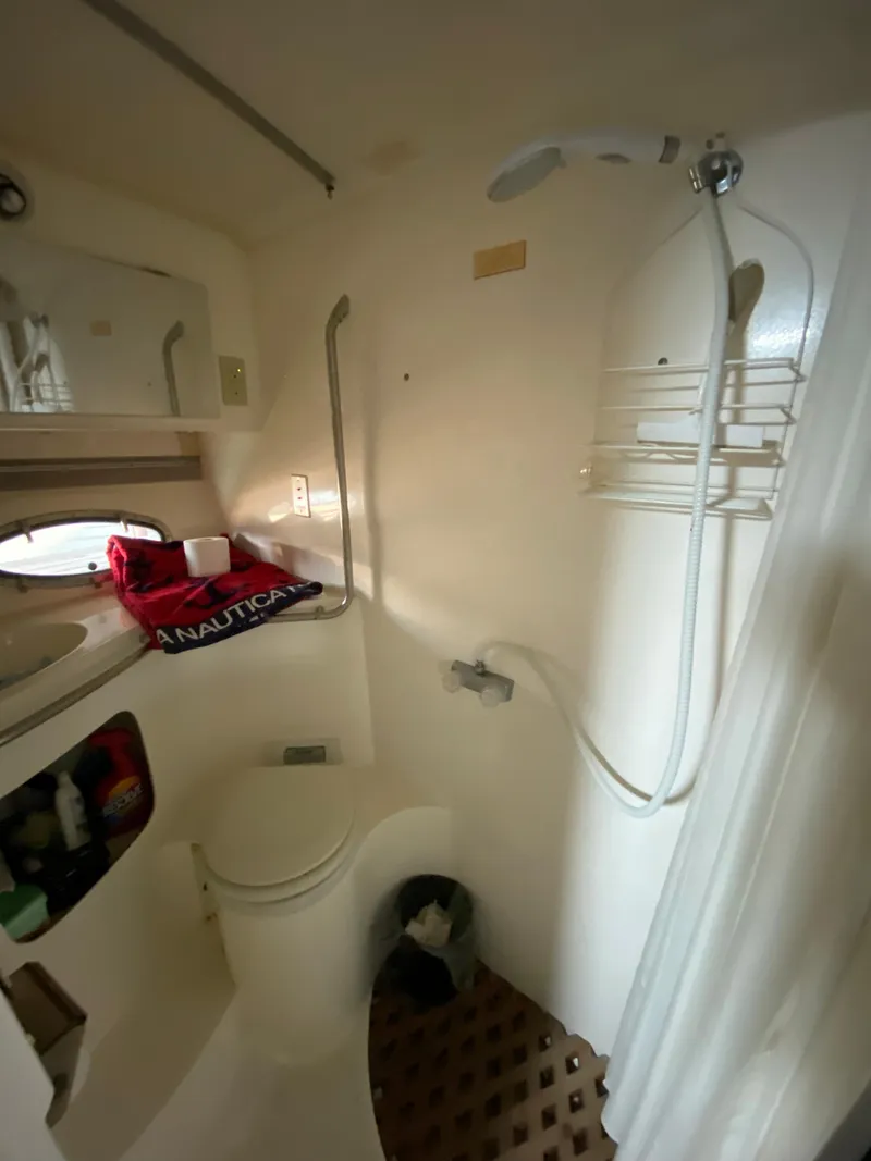 Slide: The Image of 1984 Trojan 10 Meter Sedan boat bathroom with shower, sink, and toilet. - 36