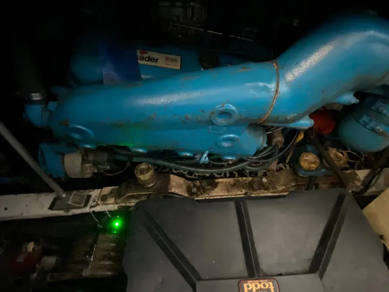 Slide: The Image of 1984 Trojan 10 Meter Sedan engine compartment with blue engine components. - 39