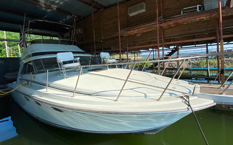 Slide: The Image of 1984 Trojan 10 Meter Sedan boat docked in a covered marina. - 8