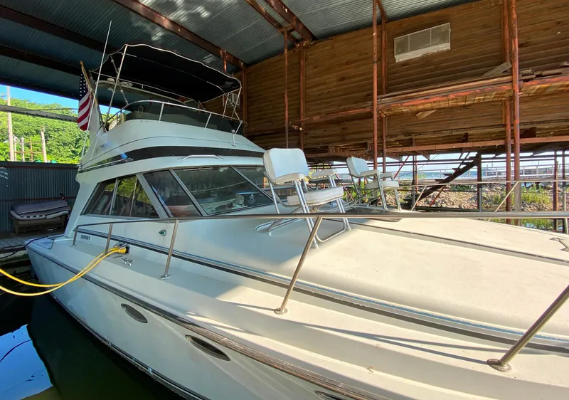 Slide: The Image of 1984 Trojan 10 Meter Sedan boat docked in a covered marina. - 9