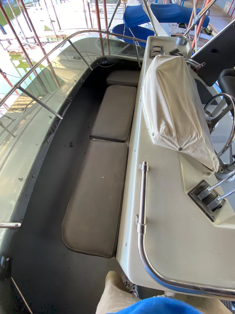 Slide: The Image of 1984 Trojan 10 Meter Sedan boat interior with seating and control panel. - 19