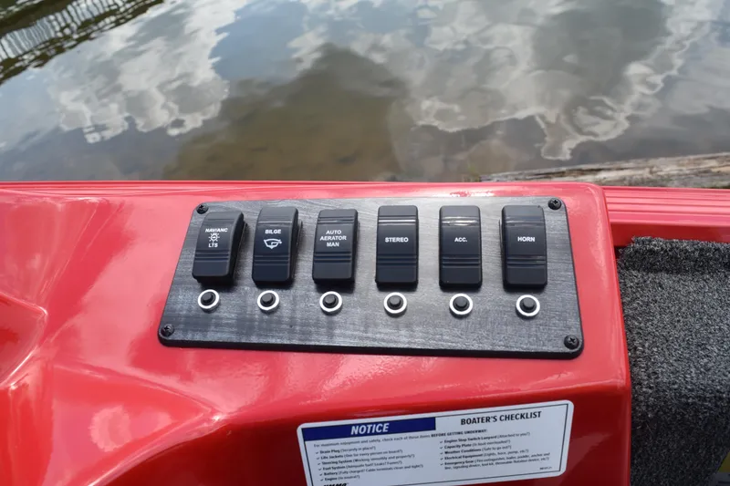 Slide: The Image of Control panel of a 2022 Polar Kraft Bass TX 195 Pro boat with various switches. - 11