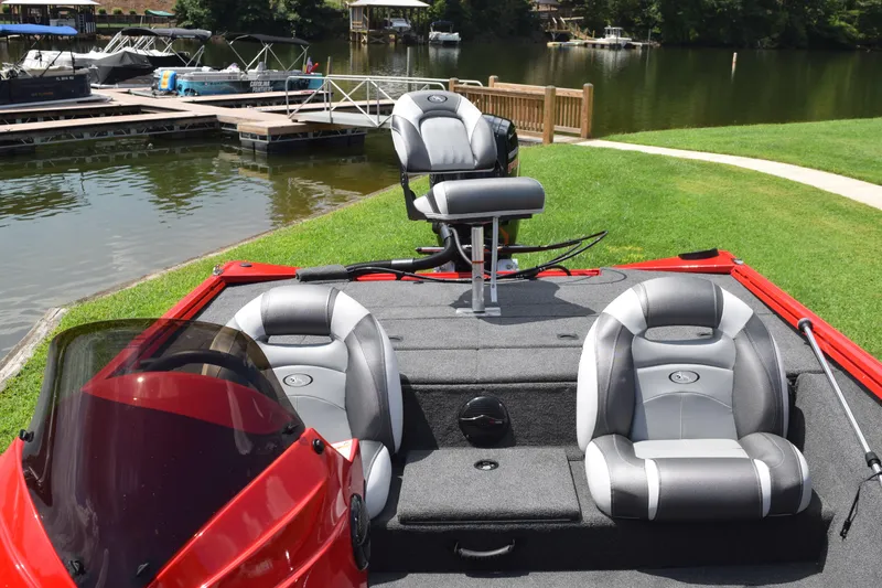 Slide: The Image of 2022 Polar Kraft Bass TX 195 Pro boat with seating, docked by a lake. - 16