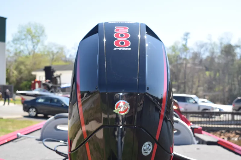 Slide: The Image of 2022 Polar Kraft Bass TX 195 Pro boat engine, black with red accents, outdoors. - 2