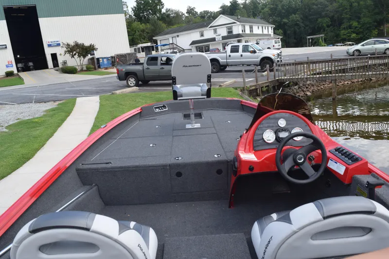 Slide: The Image of 2022 Polar Kraft Bass TX 195 Pro boat interior with steering wheel and seating. - 8