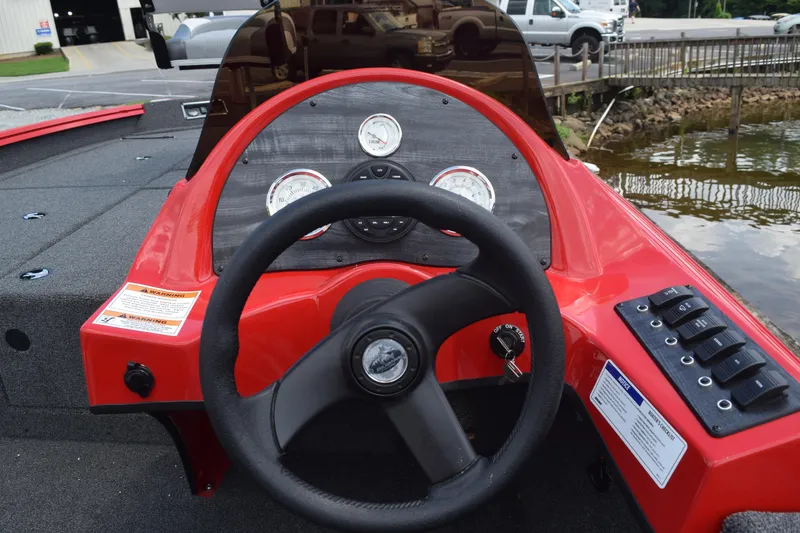 Slide: The Image of 2022 Polar Kraft Bass TX 195 Pro boat dashboard with steering wheel and gauges. - 9