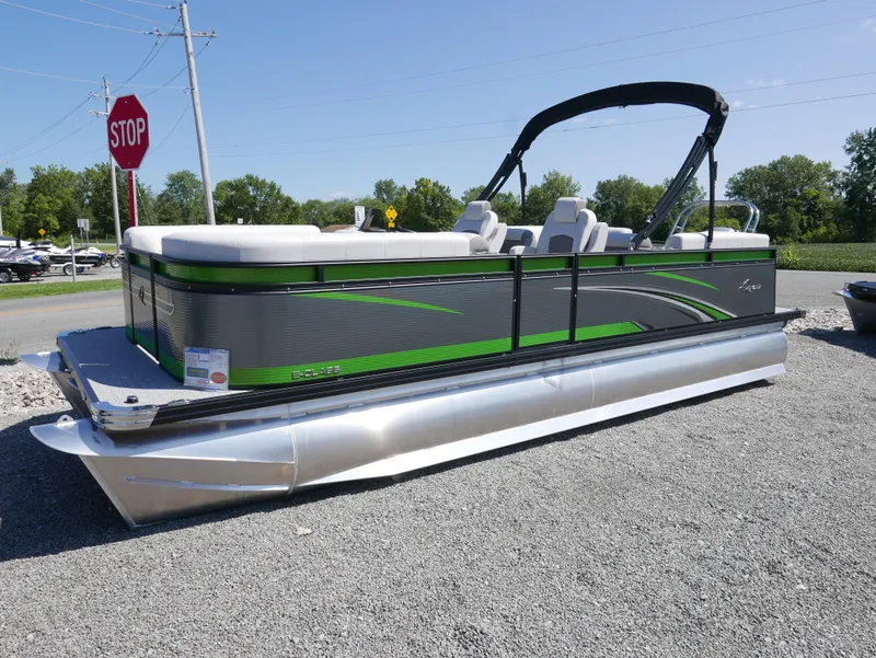 Slide: The Image of 2023 Qwest E-Class 822 RLS LTZ pontoon boat with green accents on display. - 1