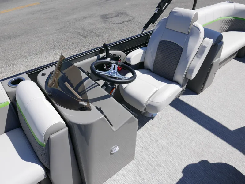 Slide: The Image of 2023 Qwest E-Class 822 RLS LTZ boat interior with steering console and seating. - 11