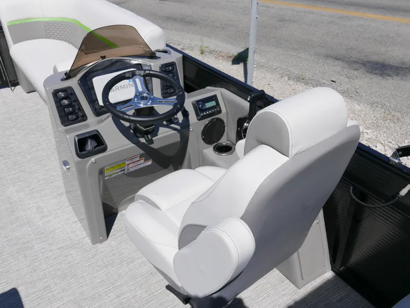 Slide: The Image of 2023 Qwest E-Class 822 RLS LTZ boat interior with steering console and captain's chair. - 12