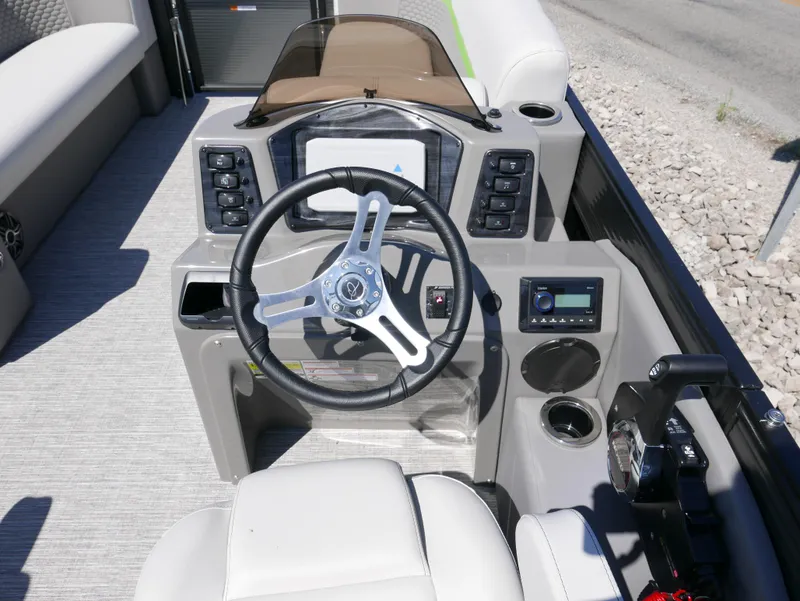 Slide: The Image of 2023 Qwest E-Class 822 RLS LTZ boat dashboard with steering wheel and control panel. - 13