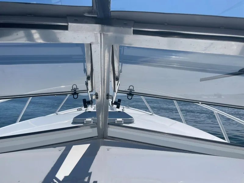 Slide: The Image of 1995 Blackfin 29-2 Combi boat view through windshield on open water. - 10