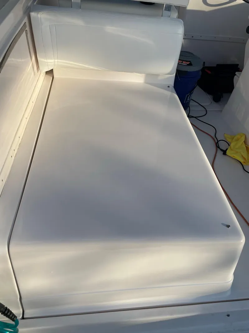 Slide: The Image of 1995 Blackfin 29-2 Combi boat interior with white cushioned seating. - 13