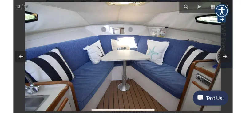 Slide: The Image of Interior of 1995 Blackfin 29-2 Combi boat with blue seating and a central table. - 18