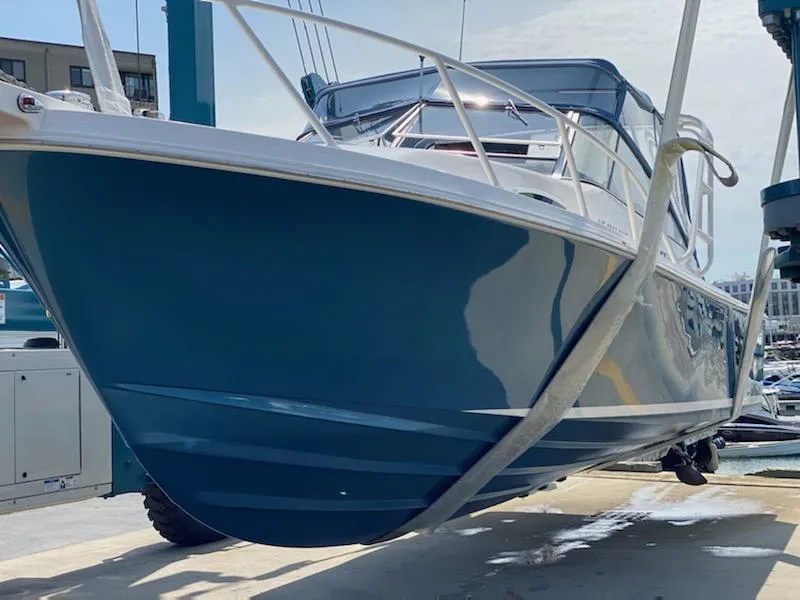 Slide: The Image of 1995 Blackfin 29-2 Combi boat on lift, blue hull, marina background. - 5