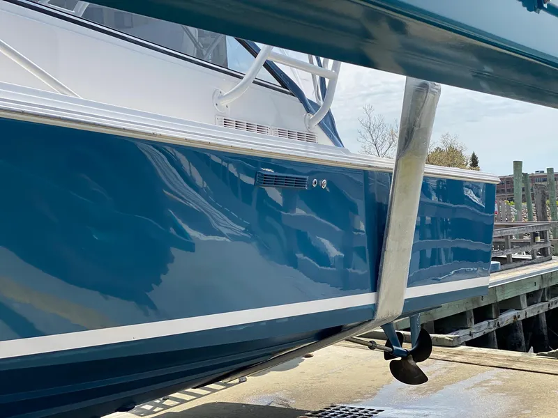 Slide: The Image of Blue 1995 Blackfin 29-2 Combi boat docked, showcasing sleek design and propeller. - 6