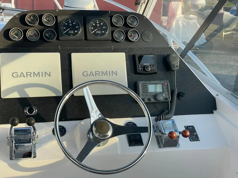 Slide: The Image of 1995 Blackfin 29-2 Combi boat dashboard with Garmin displays and steering wheel. - 17