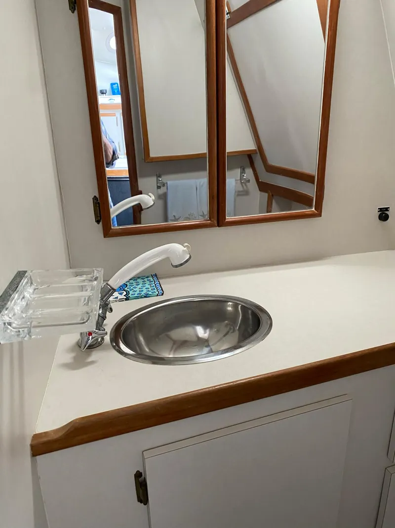 Slide: The Image of 1995 Blackfin 29-2 Combi bathroom with sink, mirror, and wooden accents. - 20