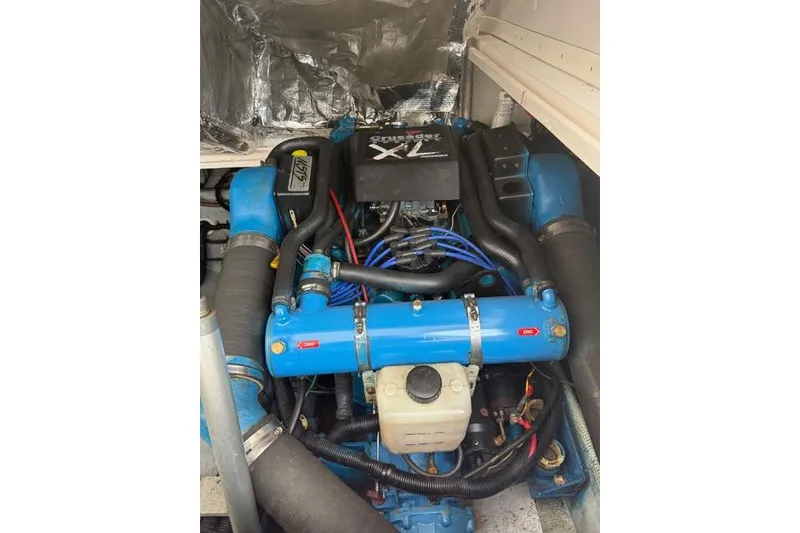 Slide: The Image of Engine compartment of a 1995 Blackfin 29-2 Combi boat, featuring a blue marine engine. - 24