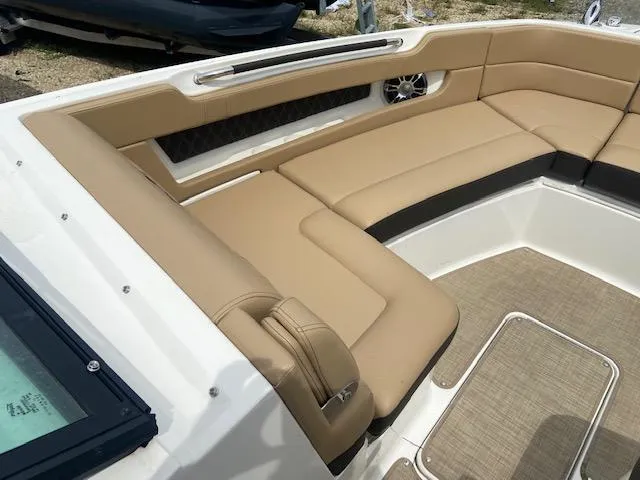 Slide: The Image of 2021 Sea Ray 310 SLX boat with tan leather seating and spacious interior. - 10