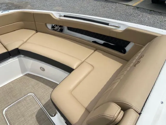 Slide: The Image of 2021 Sea Ray 310 SLX boat with beige leather seating and modern interior design. - 11